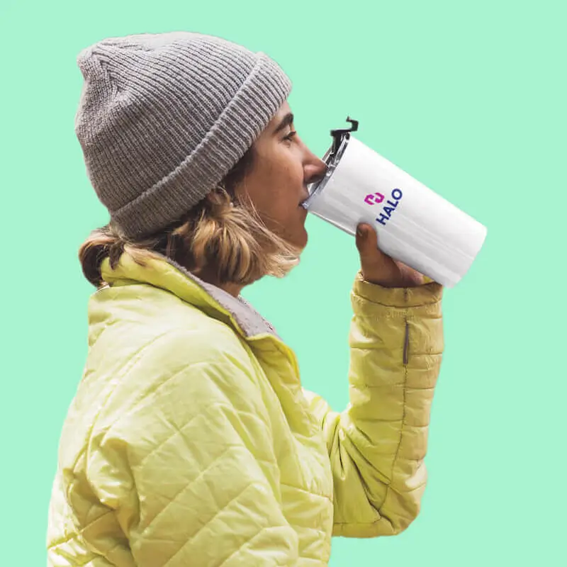 Woman drinking out of HALO branded water bottle